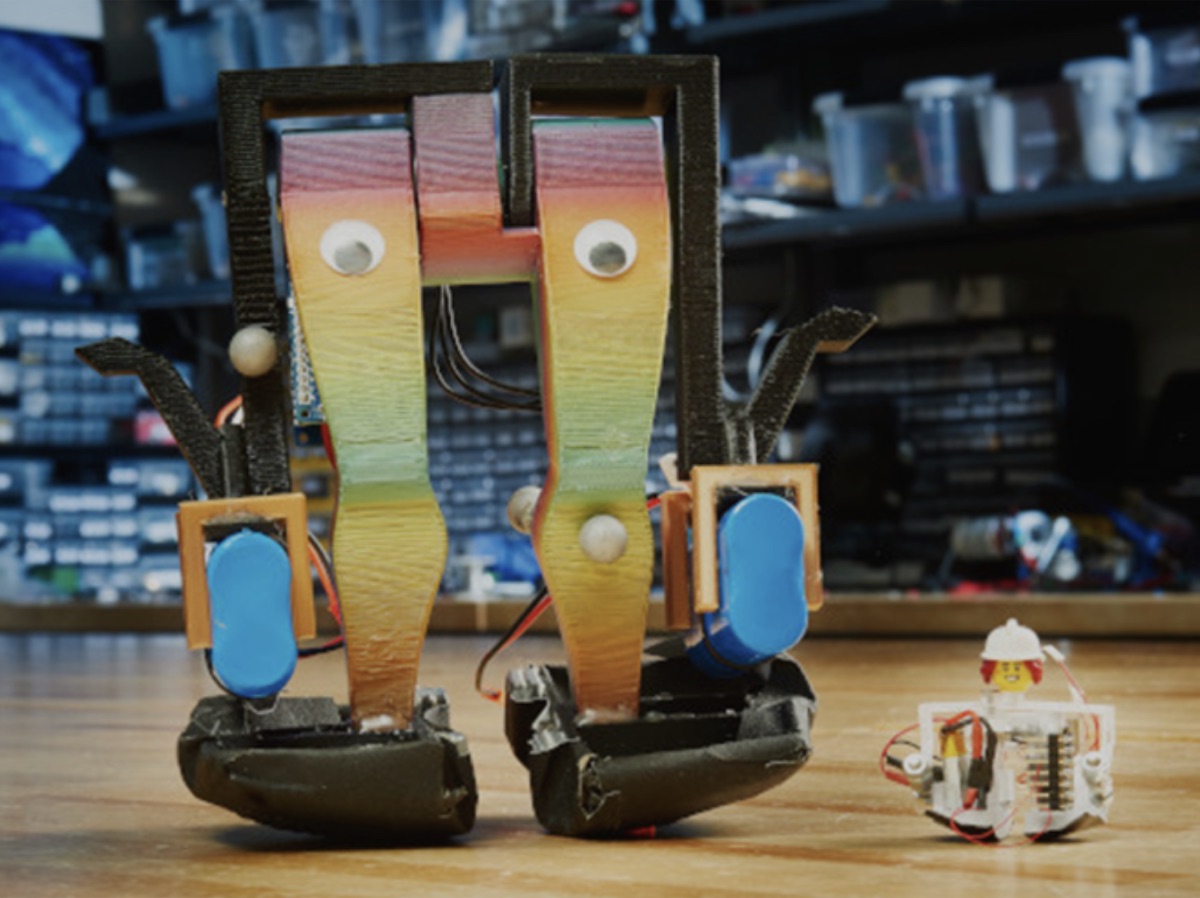Zippy, the world's smallest bipedal robot, beside a LEGO minifigure for scale